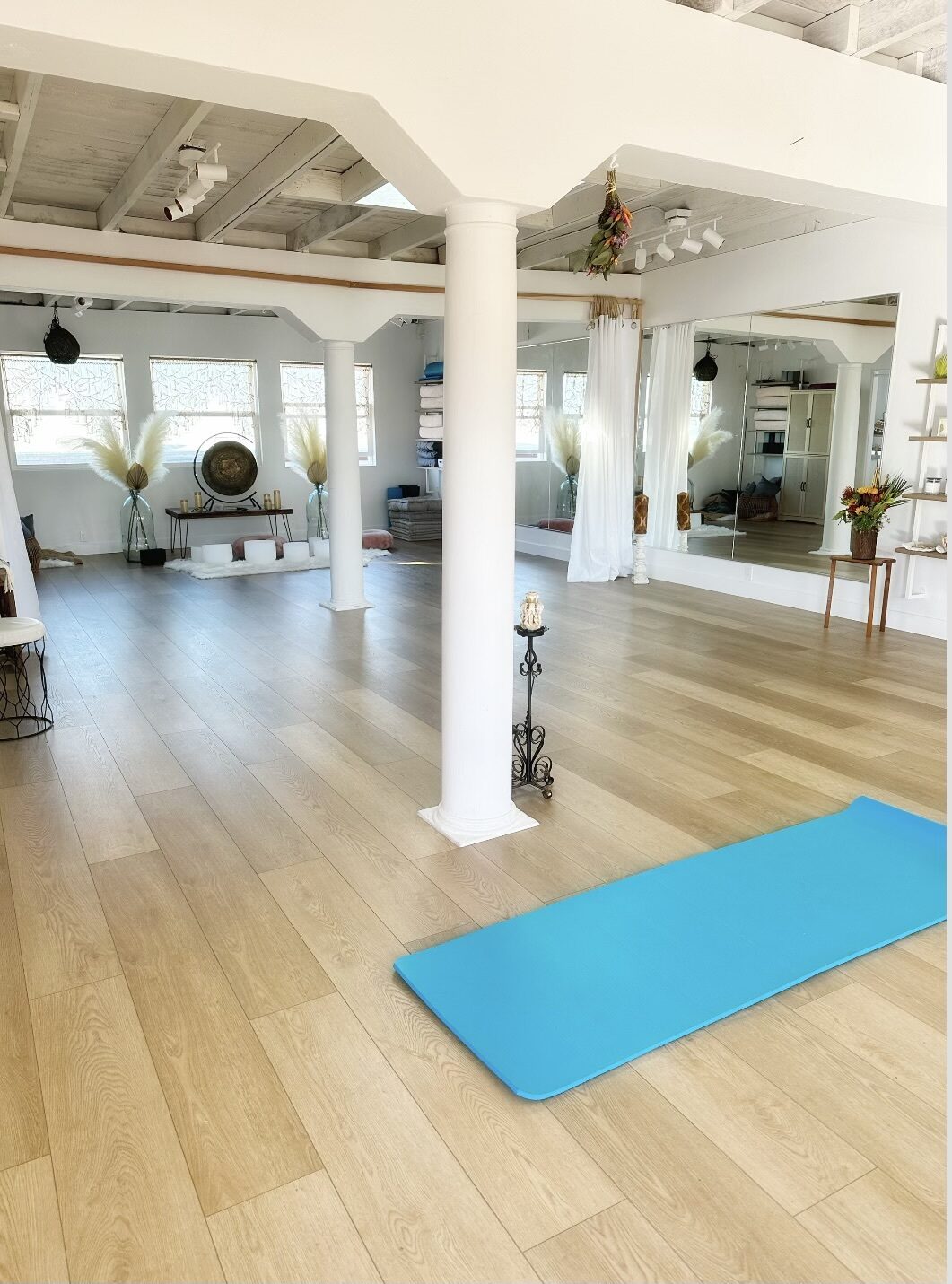 Sunlit Zen studio with gong, crystal bowls and pampas grass